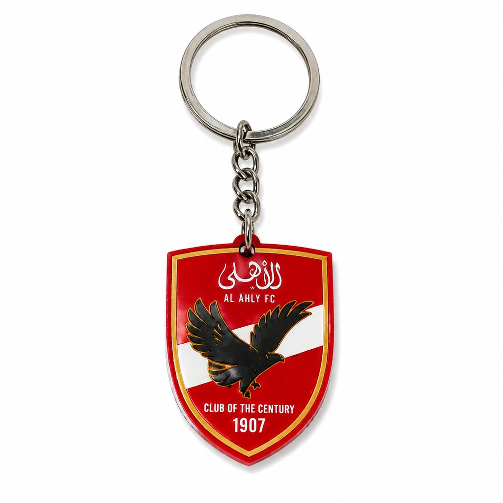 Keychain with a red shield design featuring an eagle and text on a white background