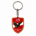 Keychain with a red shield design featuring an eagle and text on a white background